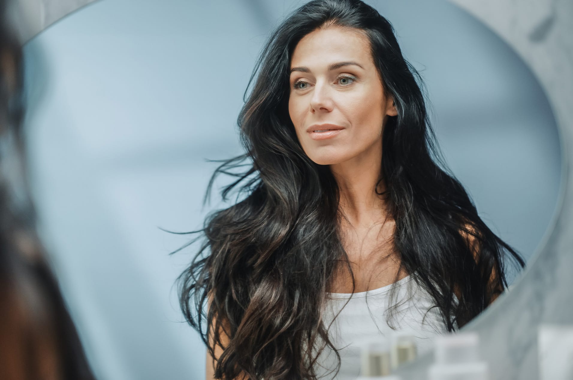 Woman looking into mirror