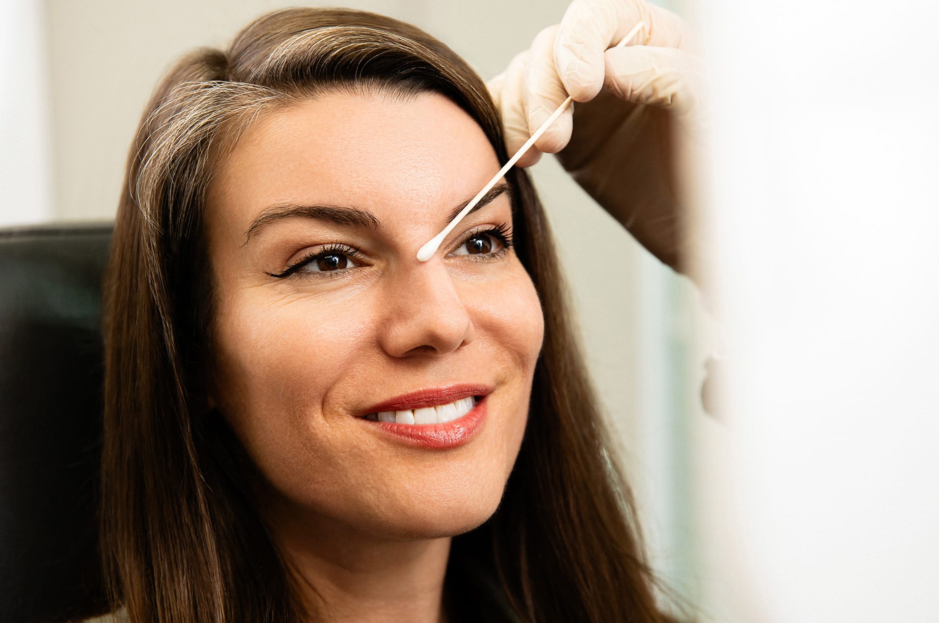 woman with a q-tip on her nose