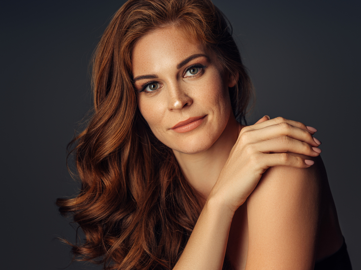 Woman with her hand on her shoulder